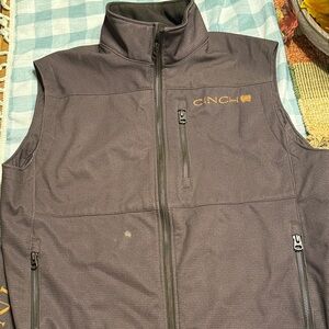 Cinch dark brown vest with tan logo. Size small.